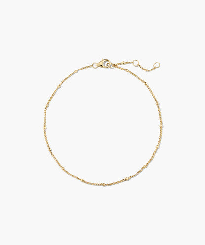 Pulseira dourada com esferas