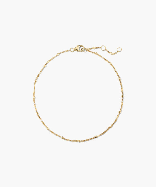 Pulseira dourada com esferas